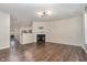 Bright living room with fireplace, hardwood floors, and open access to the kitchen at 155 Jade St, Smithfield, NC 27577