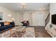 Inviting living room with a stylish blue sofa, patterned rug, and elegant decor at 155 Jade St, Smithfield, NC 27577