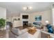 Comfortable living room with plush sofas, fireplace, and open view to the kitchen at 155 Jade St, Smithfield, NC 27577