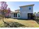 View of the home's fenced backyard with lawn and screened-in porch, perfect for outdoor entertaining at 1707 Capstone Dr, Durham, NC 27713