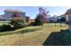 Spacious backyard with well-maintained lawn, surrounded by a black metal fence at 1707 Capstone Dr, Durham, NC 27713