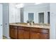 Bathroom showcasing double sinks with granite countertops and dark wood cabinets at 1707 Capstone Dr, Durham, NC 27713