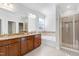 Luxurious bathroom featuring double vanity, soaking tub, and separate glass shower at 1707 Capstone Dr, Durham, NC 27713