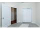 Bedroom with wood-look flooring, closet with sliding doors, open doorway, and neutral walls at 1707 Capstone Dr, Durham, NC 27713