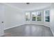 Bedroom filled with natural light, showcasing hardwood floors and large windows with blinds at 1707 Capstone Dr, Durham, NC 27713