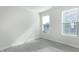 Bedroom featuring natural light from two windows, neutral paint, and wood-look flooring at 1707 Capstone Dr, Durham, NC 27713