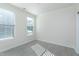 Bright bedroom with two windows letting in natural light and stylish wood-look floors at 1707 Capstone Dr, Durham, NC 27713