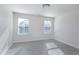 Bedroom featuring wood-look floors, natural light from two windows, and neutral wall color at 1707 Capstone Dr, Durham, NC 27713