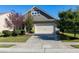 Well-maintained home exterior with a two-car garage, attractive landscaping, and a long, concrete driveway at 1707 Capstone Dr, Durham, NC 27713