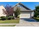Charming home exterior with a well-manicured lawn, mature trees, and a two-car garage with a concrete driveway at 1707 Capstone Dr, Durham, NC 27713