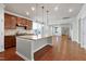 Open kitchen featuring granite countertops, stainless steel appliances, and a central island with pendant lighting at 1707 Capstone Dr, Durham, NC 27713