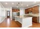 Bright, open kitchen with a central island, granite countertops, stainless steel appliances, and hardwood floors at 1707 Capstone Dr, Durham, NC 27713
