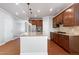 Modern kitchen with stainless steel appliances, granite counters, a spacious island, and hardwood flooring at 1707 Capstone Dr, Durham, NC 27713