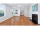 Bright living room with a fireplace, windows, hardwood floors, and a view of the staircase at 1707 Capstone Dr, Durham, NC 27713