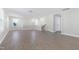 Bright living room showcasing wood-look floors, many windows, open floor plan and staircase access at 1707 Capstone Dr, Durham, NC 27713