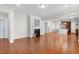 Spacious living room featuring fireplace, hardwood floors, and open flow to kitchen area at 1707 Capstone Dr, Durham, NC 27713