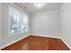 Bright room showcasing hardwood floors, a large window, and neutral walls, perfect for versatile use at 1707 Capstone Dr, Durham, NC 27713