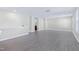 Open-concept living room featuring wood-look flooring, access to other rooms, and ample natural light at 1707 Capstone Dr, Durham, NC 27713