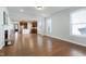 Open floor plan with hardwood floors and views into the kitchen and front entrance at 1707 Capstone Dr, Durham, NC 27713