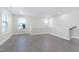 Well-lit living room with wood-look floors, many windows, and a neutral color palette at 1707 Capstone Dr, Durham, NC 27713