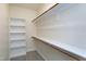 Spacious walk-in closet with built-in shelving and hanging rods for optimal organization at 1707 Capstone Dr, Durham, NC 27713