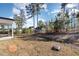 Spacious backyard featuring a black iron fence and mature trees, providing privacy at 192 Kensington Dr, Spring Lake, NC 28390