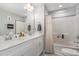 Well-lit bathroom with double sinks, a spacious counter, and a shower-tub combination, blending style and functionality at 192 Kensington Dr, Spring Lake, NC 28390