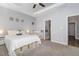 Bright and airy bedroom with plush carpet, tray ceiling, and easy access to the ensuite bathroom at 192 Kensington Dr, Spring Lake, NC 28390