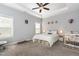 Calming bedroom with a tray ceiling, neutral walls, a ceiling fan, and ample natural light at 192 Kensington Dr, Spring Lake, NC 28390