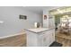 Bright kitchen island featuring granite countertops and white cabinetry, perfect for meal prep and entertaining at 192 Kensington Dr, Spring Lake, NC 28390