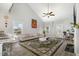 Bright living room featuring a vaulted ceiling, ceiling fan, large rug, and comfortable seating at 192 Kensington Dr, Spring Lake, NC 28390