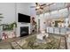 Cozy living room with fireplace, large television, and staircase leading to the second floor at 192 Kensington Dr, Spring Lake, NC 28390