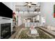 Open-concept living space with fireplace, loft, and kitchen view with bar seating at 192 Kensington Dr, Spring Lake, NC 28390