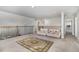 Bright loft with plush carpet, comfortable seating, and ample natural light, perfect for relaxation and entertainment at 192 Kensington Dr, Spring Lake, NC 28390