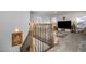 Beautiful staircase featuring dark iron spindles and light wood bannister, leading to the upper level living area at 192 Kensington Dr, Spring Lake, NC 28390