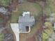 Aerial view showcasing a home with a concrete patio, wooded backyard, and long driveway for ample privacy at 20 Crane Dr, Louisburg, NC 27549