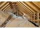 Large attic area with wooden rafters and insulation, ready to be transformed into additional living space at 20 Crane Dr, Louisburg, NC 27549
