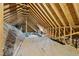 Spacious unfinished attic with exposed wood beams and insulation, offering potential for customization at 20 Crane Dr, Louisburg, NC 27549
