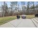 View of the backyard with a concrete patio featuring barbecue grills, perfect for outdoor entertaining at 20 Crane Dr, Louisburg, NC 27549