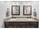 Bathroom with dual sinks and dark wood cabinets at 20 Crane Dr, Louisburg, NC 27549
