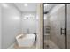 Modern bathroom featuring a standalone soaking tub and separate glass-enclosed shower at 20 Crane Dr, Louisburg, NC 27549