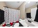 Bathroom featuring a Mickey Mouse shower curtain, vanity, and mirror, creating a cheerful ambiance at 20 Crane Dr, Louisburg, NC 27549