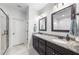 Bathroom with double vanities, granite countertop, and walk-in shower at 20 Crane Dr, Louisburg, NC 27549