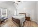 Cozy bedroom with vaulted ceiling, wood flooring, and a comfortable wooden bed at 20 Crane Dr, Louisburg, NC 27549