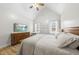 Spacious primary bedroom featuring wood floors, a large dresser, and lots of natural light at 20 Crane Dr, Louisburg, NC 27549