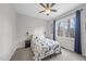 Inviting bedroom features a floral bedspread, ceiling fan, and a large window at 20 Crane Dr, Louisburg, NC 27549