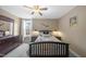 Comfortable bedroom with neutral colors, a ceiling fan, and ample natural light from a nearby window at 20 Crane Dr, Louisburg, NC 27549