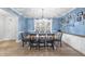 Bright dining room features a wooden table with seating for six and blue accent walls at 20 Crane Dr, Louisburg, NC 27549