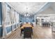 Open-concept dining area showcasing a modern table, leading to a bright, white kitchen at 20 Crane Dr, Louisburg, NC 27549