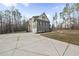 Long concrete driveway leading to a two-car garage and landscaped yard, ensuring privacy and ample parking at 20 Crane Dr, Louisburg, NC 27549